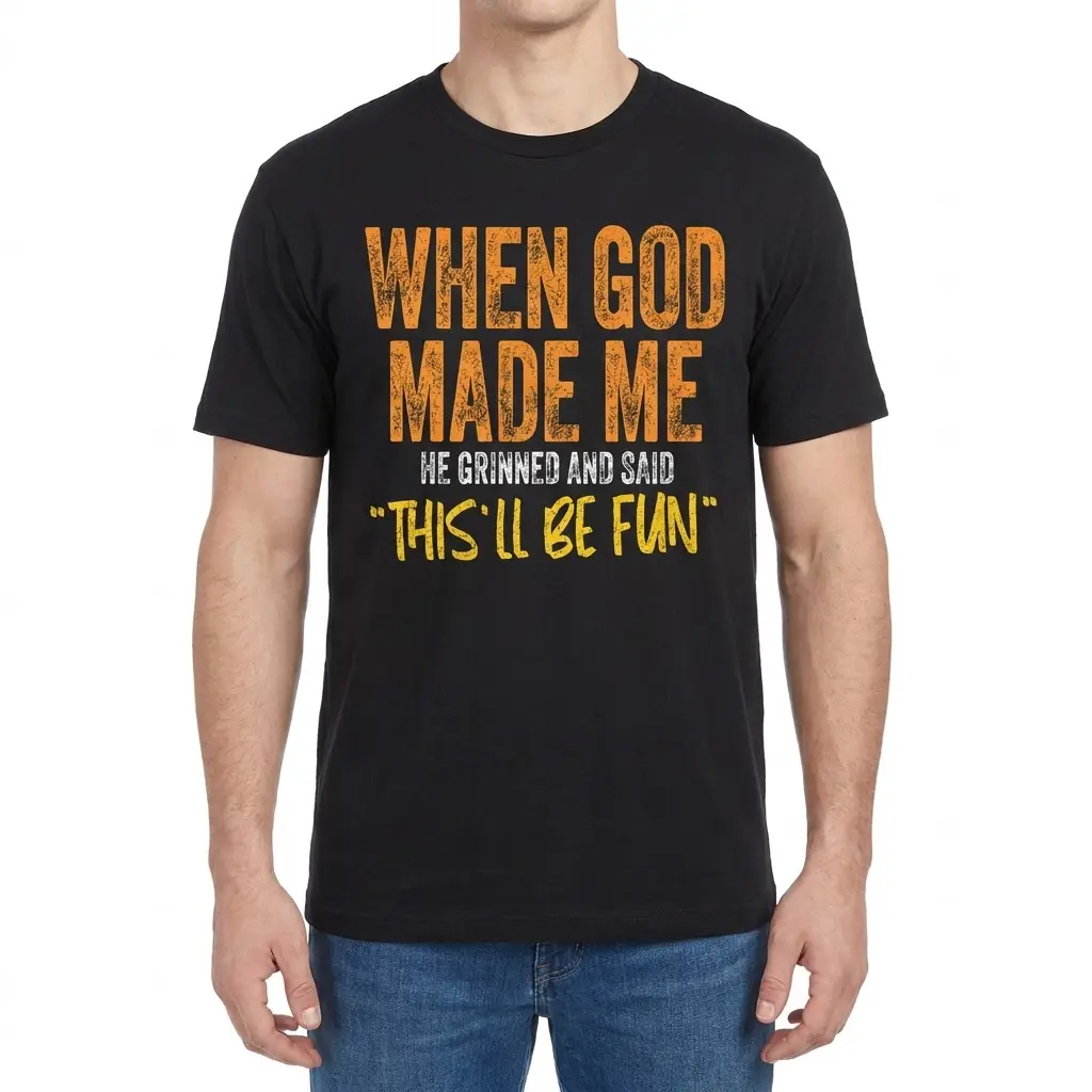 Man wearing a black t-shirt printed with "When God Made Me He Grinned And Said 'This'll Be Fun'" across the chest.