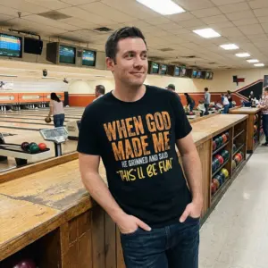 When God Made Me Funny Christian T-Shirt 11 Close-up lifestyle shot of the humorous graphic t-shirt reading "When God Made Me He Grinned And Said 'This'll Be Fun'".