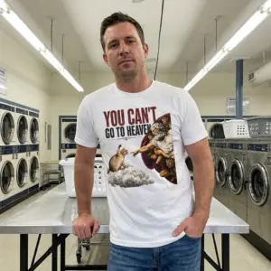 You Can't Go to Heaven Cat Swatting Parody T-Shirt 11 Cat parody T-shirt design showing a raised-paw cat facing a pointing figure among clouds.