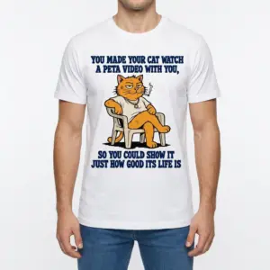 You Made Your Cat Watch A PETA Video Funny Satire T-Shirt 9 Man wearing white graphic tee with white tee front print reading YOU MADE YOUR CAT WATCH A PETA VIDEO WITH YOU above a cartoon orange cat