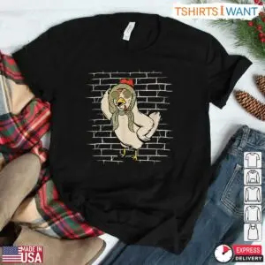 Black flat lay t-shirt styled with plaid flannel showing a cool white chicken in a green bandana and sunglasses
