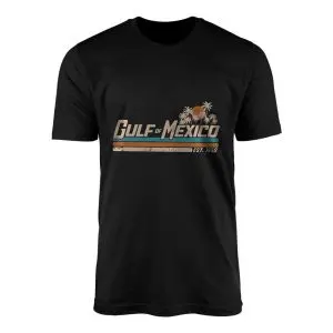 Black crew neck t-shirt flat lay featuring retro Gulf of Mexico Est 1550 sunset palm trees and vintage stripes