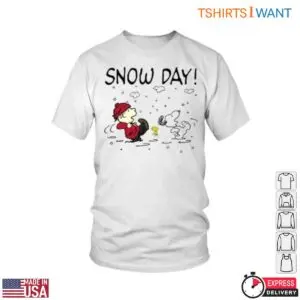 White t-shirt featuring Charlie Brown, Snoopy and Woodstock playing in falling snow under Snow Day! text